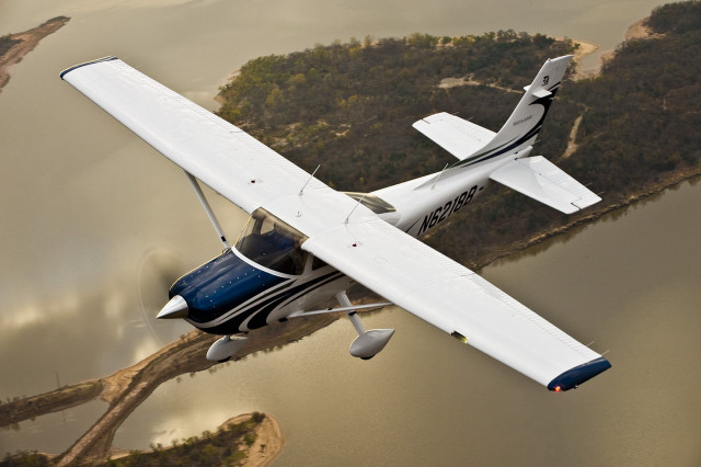 Small airplane flying lake forest free wallpaper - medium preview image