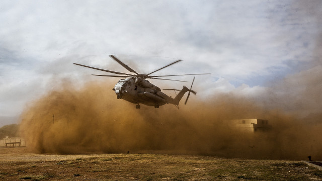 Helicopter dirt field cloudy sky free wallpaper - medium preview image