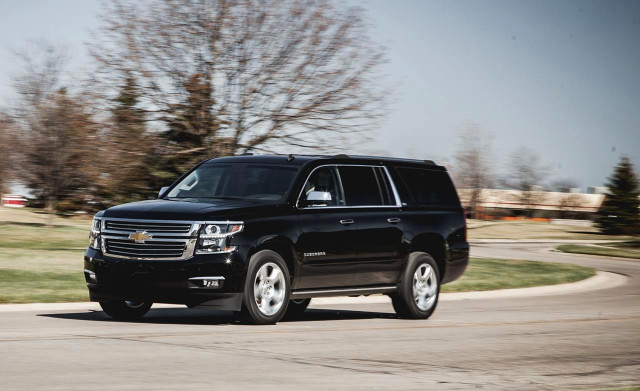 Black suv driving road tree free wallpaper - medium preview image