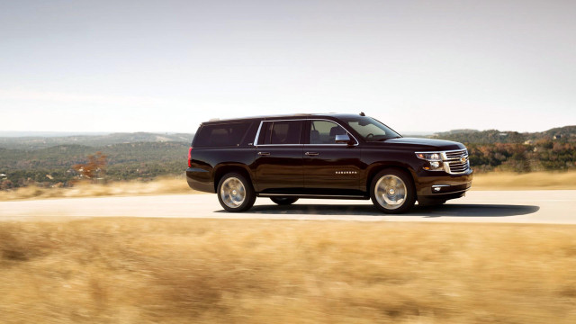 Black suv driving grass field free wallpaper - medium preview image