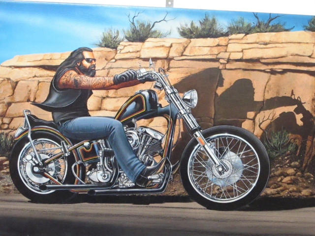 Man motorcycle rock wall desert free wallpaper - medium preview image