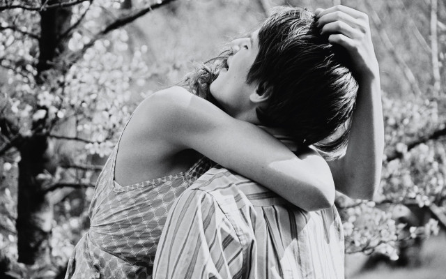 Woman hugging head forest blurry free wallpaper - medium preview image