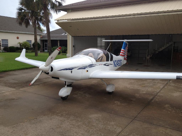 Small airplane parked house flag free wallpaper - medium preview image