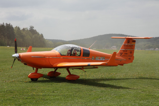 Orange plane green field mountains free wallpaper - medium preview image
