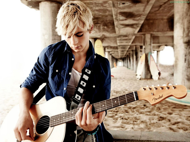 Man holding guitar beach pier free wallpaper - medium preview image