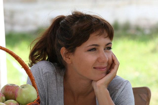 Woman sitting table basket apples free wallpaper - medium preview image
