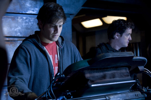 Two men standing room machine free wallpaper - medium preview image