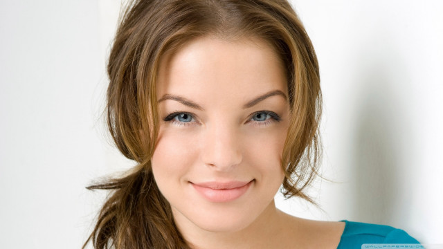 Woman blue shirt ponytail smiling free wallpaper - medium preview image