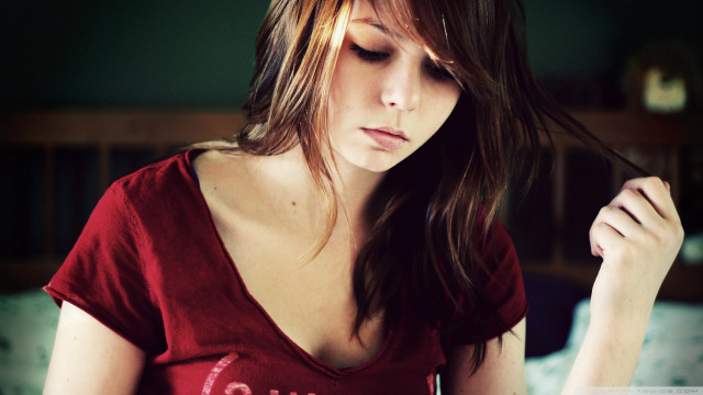 Woman red shirt sitting bed free wallpaper - medium preview image