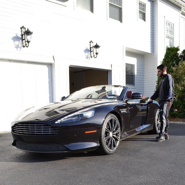 Man black car white building free wallpaper - medium preview image