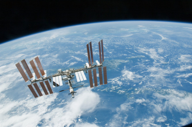 Satellite flying over earth clouds free wallpaper - medium preview image