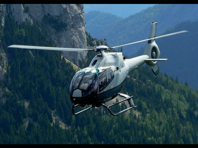 Helicopter flying mountain forest background free wallpaper - medium preview image