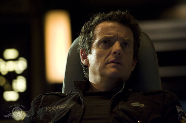 Man sitting serious look chair free wallpaper - medium preview image