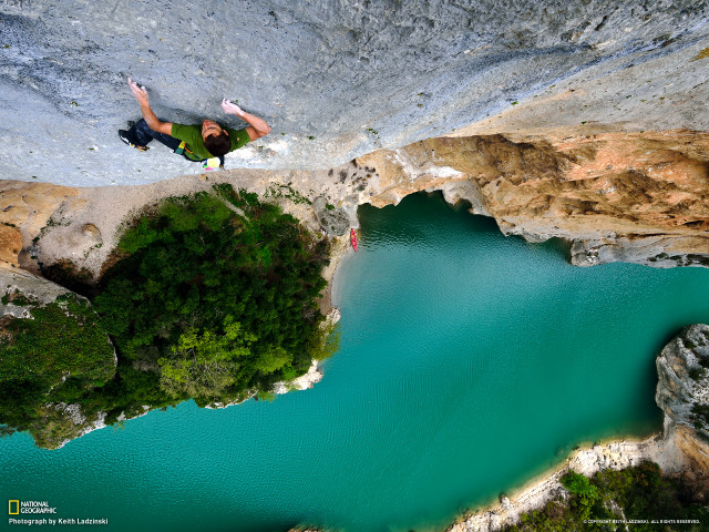 Man jumping cliff lake paraglider free wallpaper - medium preview image