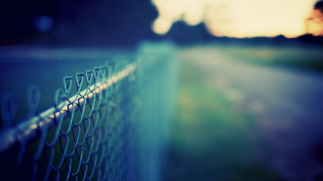 Chain link fence person walking free wallpaper - medium preview image
