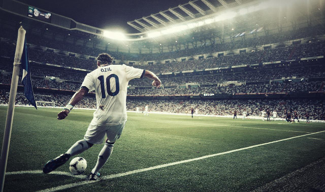 Man kicking soccer ball stadium free wallpaper - medium preview image