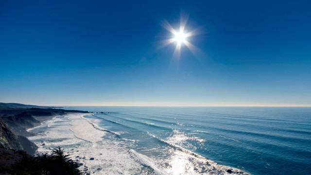 Beach sun cliff water scenery free wallpaper - medium preview image