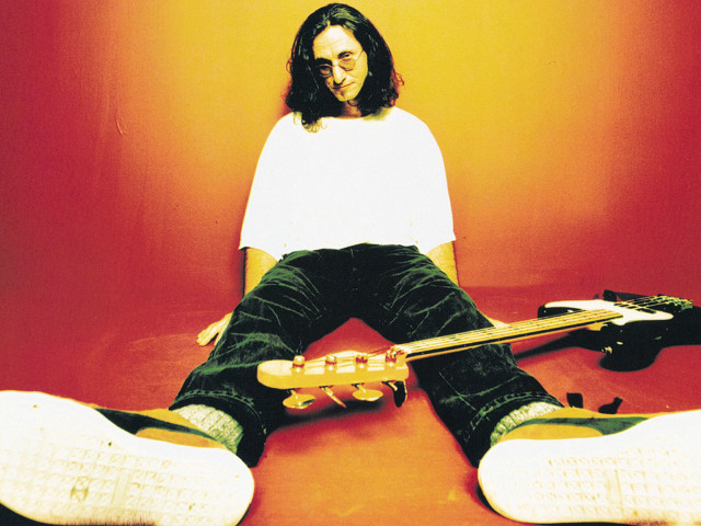 Man sitting floor guitar remote free wallpaper - medium preview image