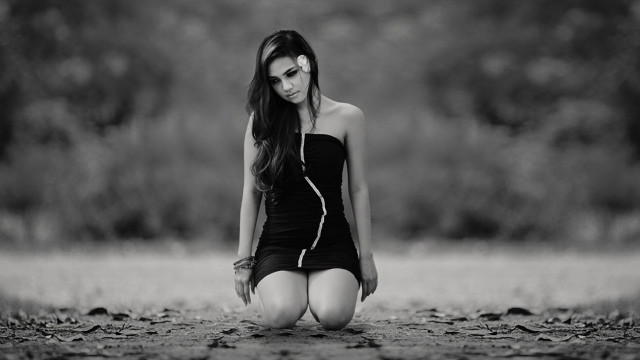 Woman black dress sitting blurry free wallpaper - medium preview image