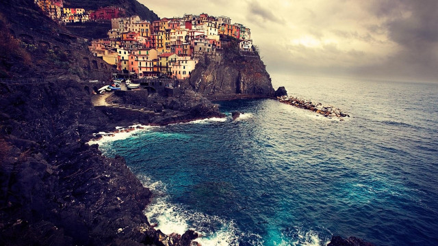 Cliffside village ocean waves boat free wallpaper - medium preview image