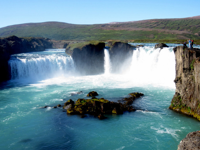 Man cliff waterfall overlooking background free wallpaper - medium preview image