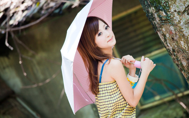 Woman holding umbrella next to free wallpaper - medium preview image