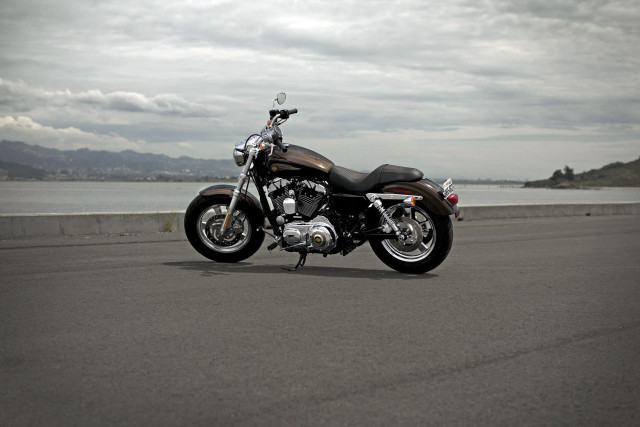 Motorcycle parked ocean mountains cloudy free wallpaper - medium preview image