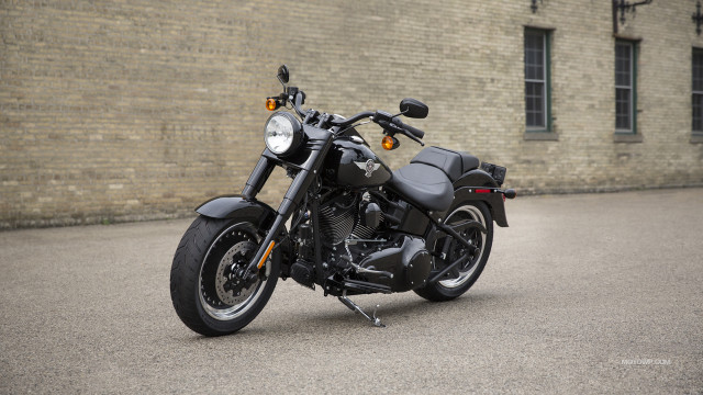 Motorcycle parked brick building wall free wallpaper - medium preview image