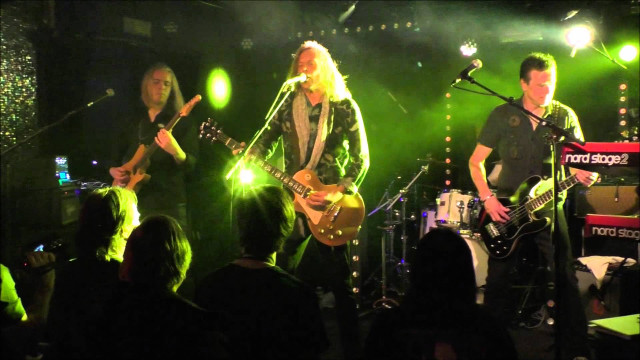 Guitarists performing on stage green free wallpaper - medium preview image