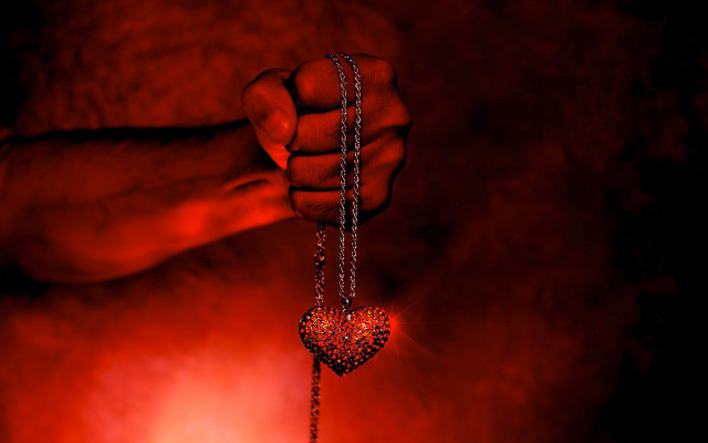 Hand holding heart shaped pendant free wallpaper - medium preview image
