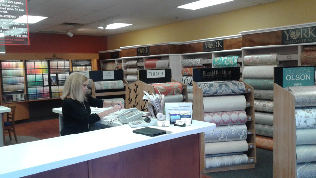 Woman sitting desk store fabrics free wallpaper - medium preview image