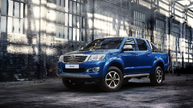 Blue truck parked building shadow free wallpaper - medium preview image