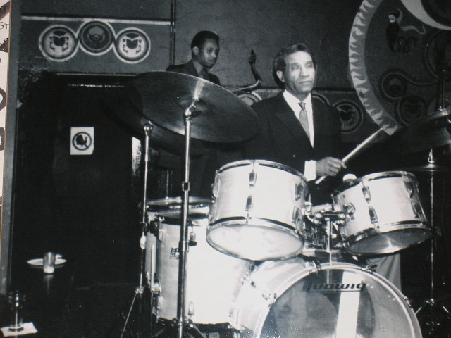 Man suit playing drums room free wallpaper - medium preview image
