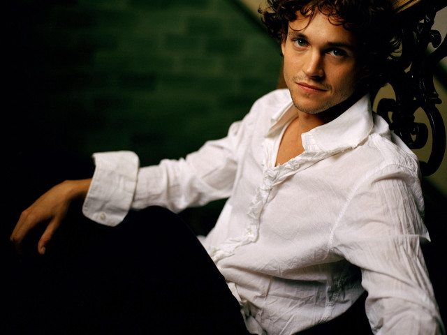 Man sitting arms crossed shirt free wallpaper - medium preview image