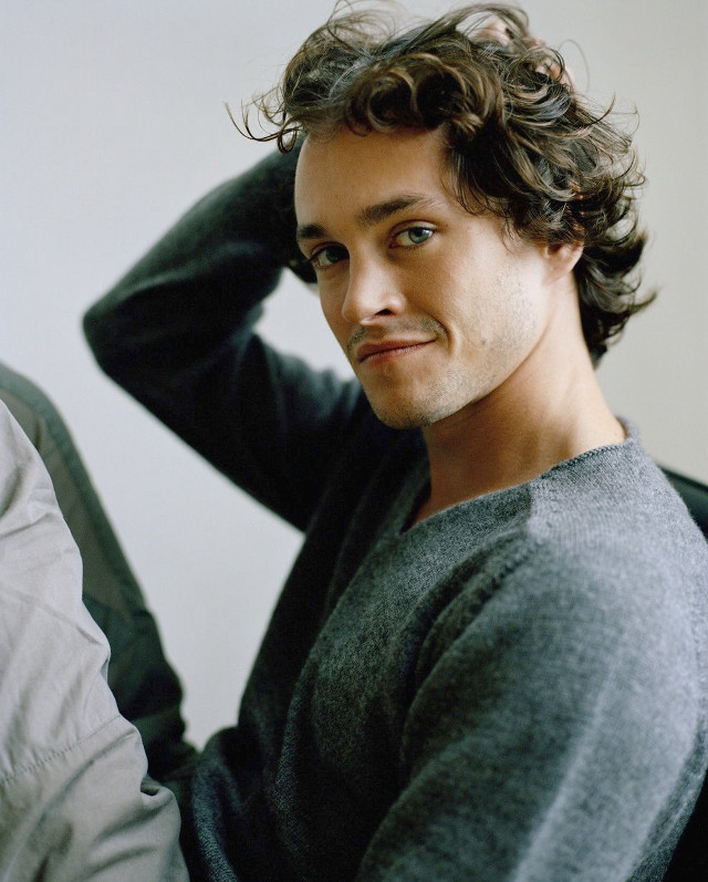 Man curly hair sitting hand free wallpaper - medium preview image