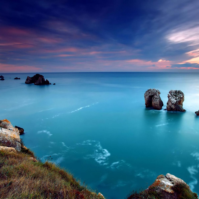 Lake rocks grassy hill cloudy free wallpaper - medium preview image