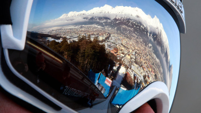 Person holding ski goggles city free wallpaper - medium preview image