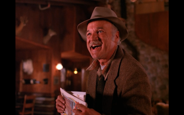Man hat holding book smiling free wallpaper - medium preview image