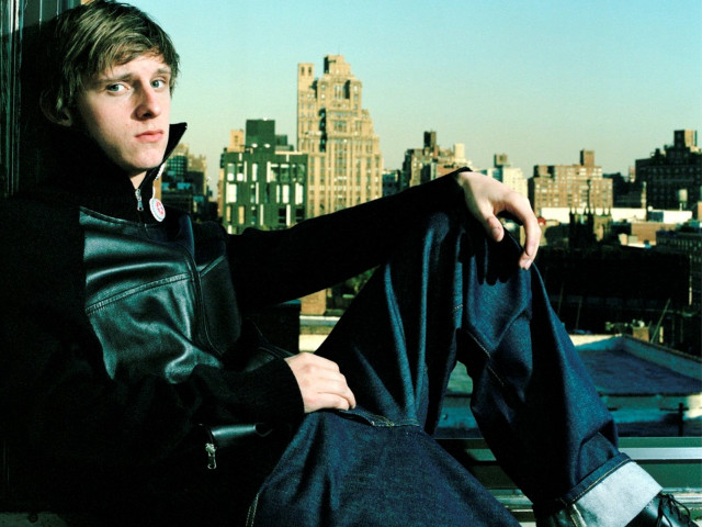 Man sitting rooftop cityscape leather free wallpaper - medium preview image