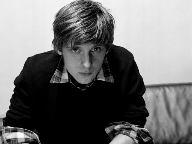 Young man couch serious look free wallpaper - medium preview image