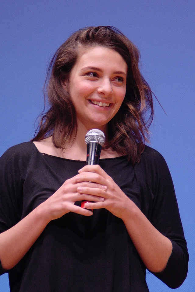 Woman holding microphone smiling blue free wallpaper - medium preview image
