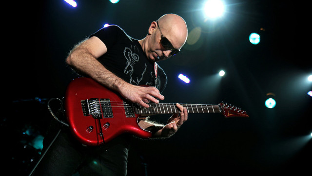 Man playing red guitar stage free wallpaper - medium preview image