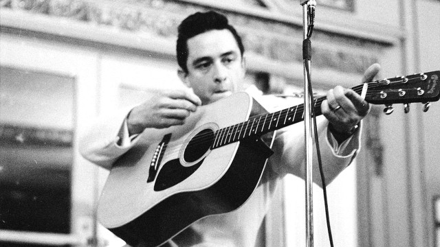 Man holding guitar microphone stand #2 free wallpaper - medium preview image
