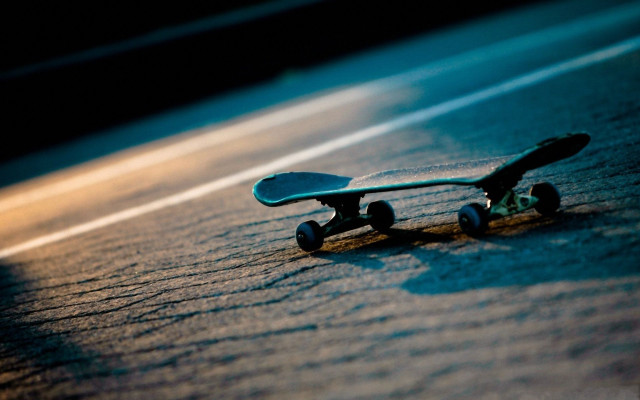 Skateboard laying ground wheels side free wallpaper - medium preview image