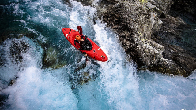 Man red kayak rock cliff free wallpaper - medium preview image