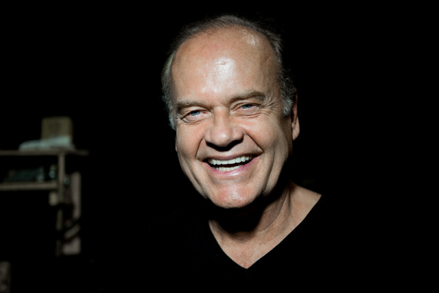 Smiling man dark chair light free wallpaper - medium preview image