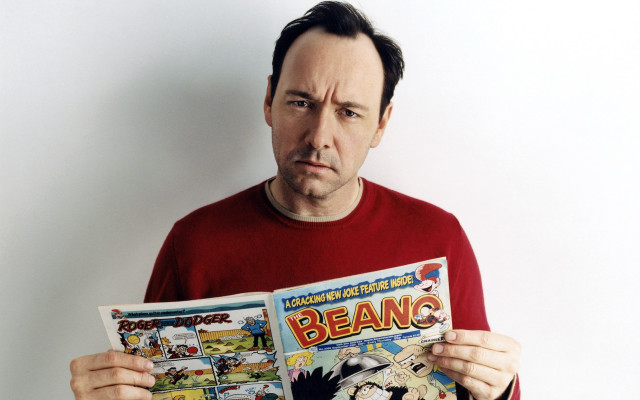 Man holding comic book frowning free wallpaper - medium preview image