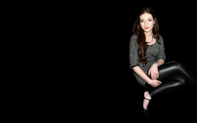 Woman leather pants gray shirt free wallpaper - medium preview image