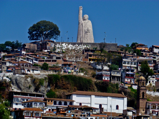 Large statue person hill buildings free wallpaper - medium preview image