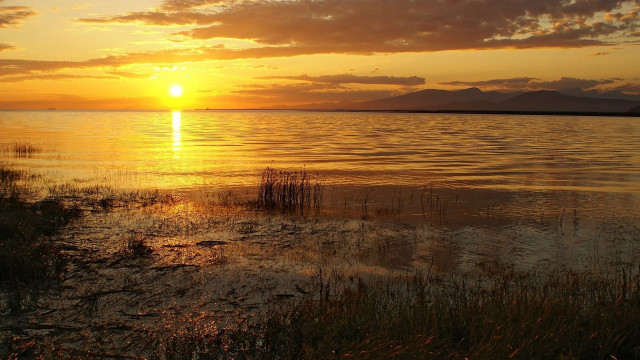 Sunset over water boat mountains free wallpaper - medium preview image